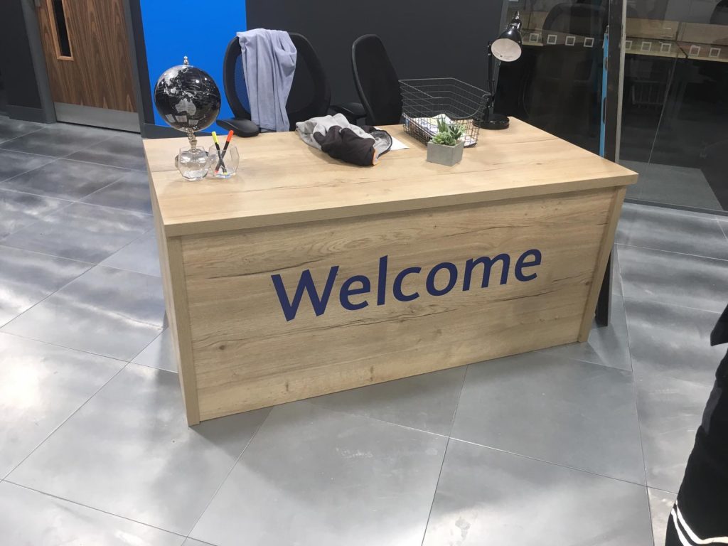 A wecome sign on a desk in an office in leeds